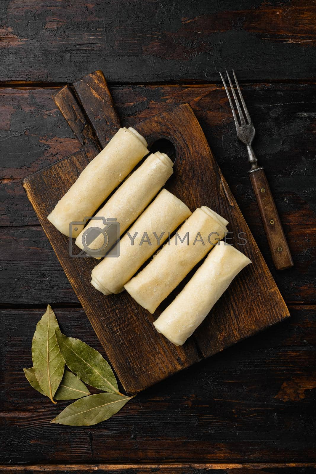 Royalty free image of Crepes frozen on old dark wooden table background, top view flat lay by Ilianesolenyi
