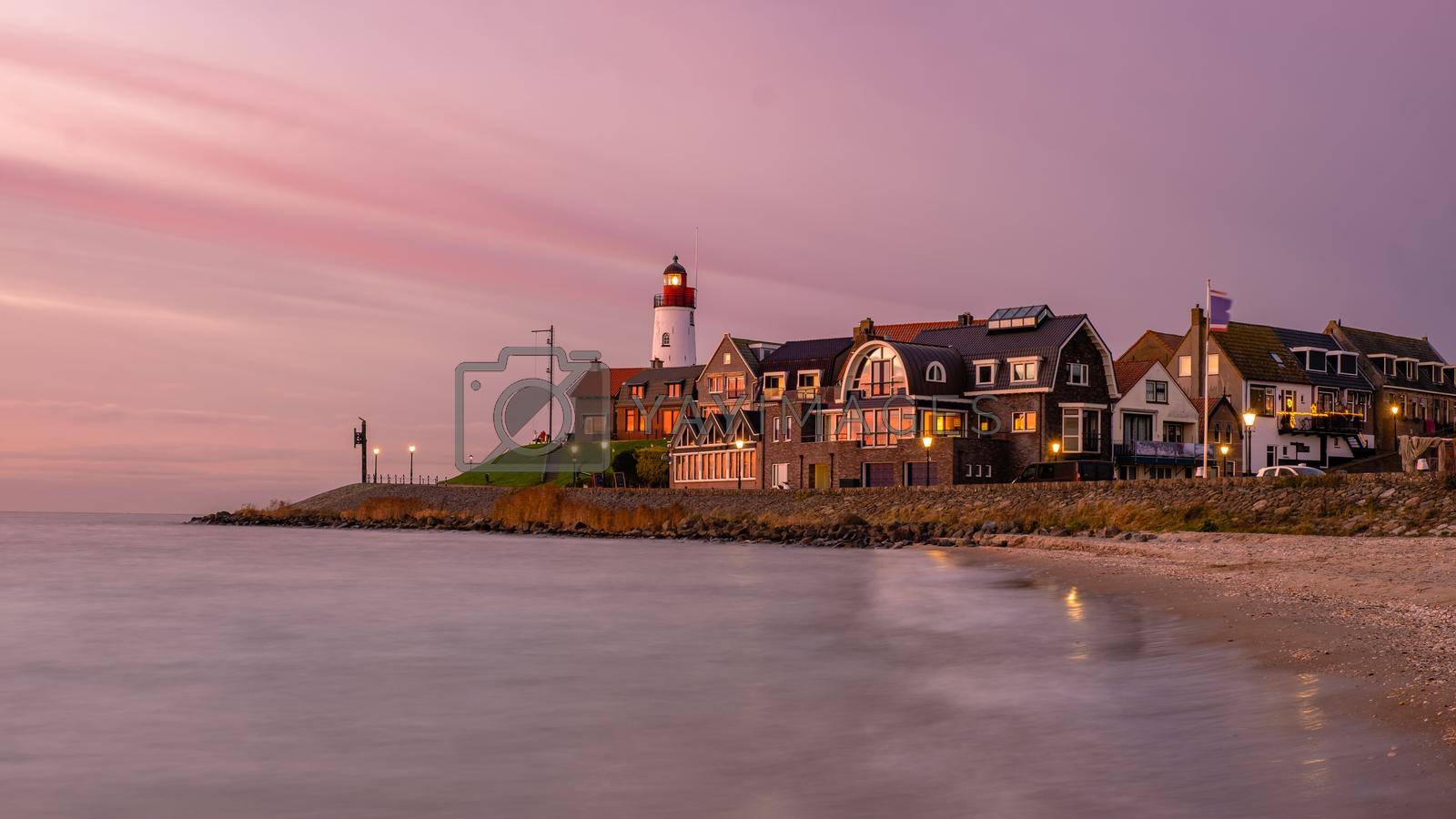 Royalty free image of Urk Flevoland Netherlands sunset at the lighthouse and harbor of Urk Holland by fokkebok