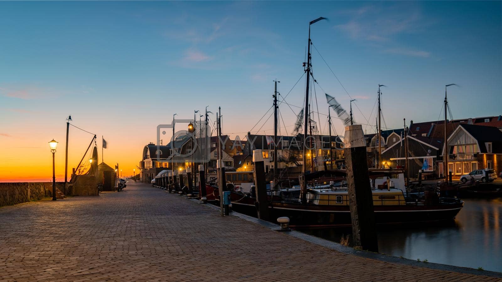 Royalty free image of Urk Flevoland Netherlands sunset at the lighthouse and harbor of Urk Holland by fokkebok