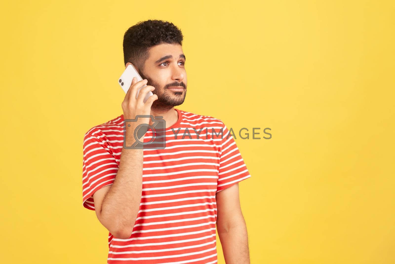 Royalty free image of Emotional young man in red t-shirt on yellow background. by Khosro1