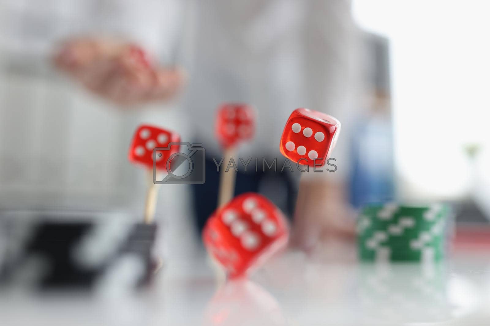 Royalty free image of Closeup of person throwing dice. Addiction to gambling concept by kuprevich