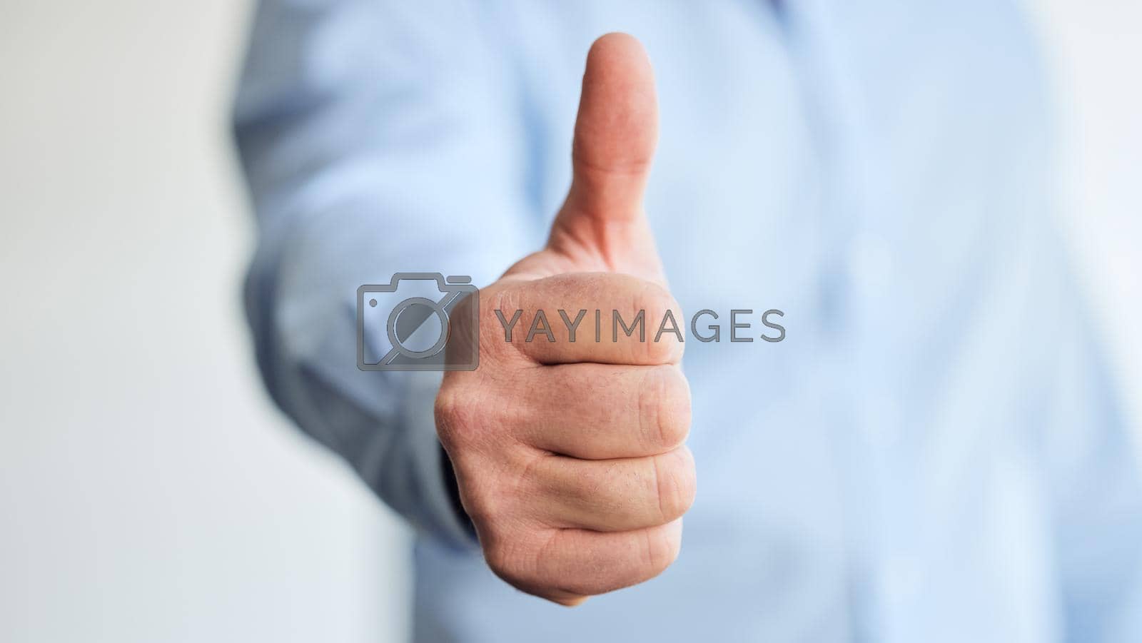 Royalty free image of Every like boosts our business. Shot of an unrecognizable businessperson showing a thumbs up at work. by YuriArcurs