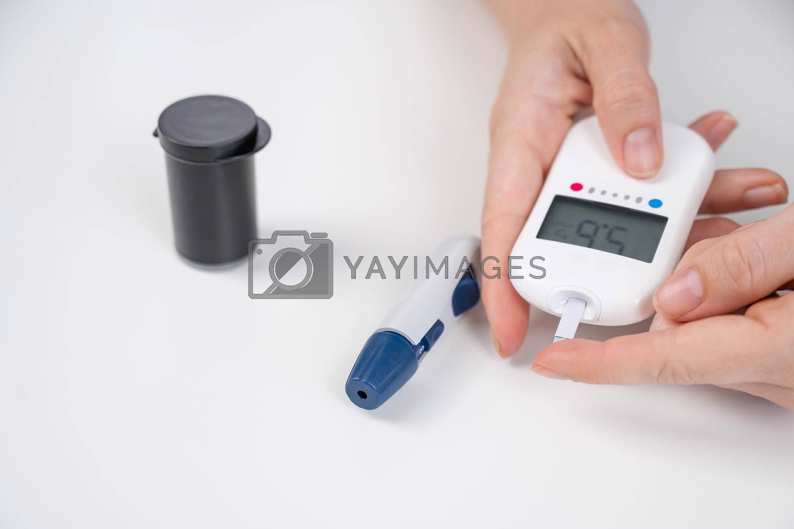 Royalty free image of Woman measures blood sugar level with a glucometer. by mrwed54