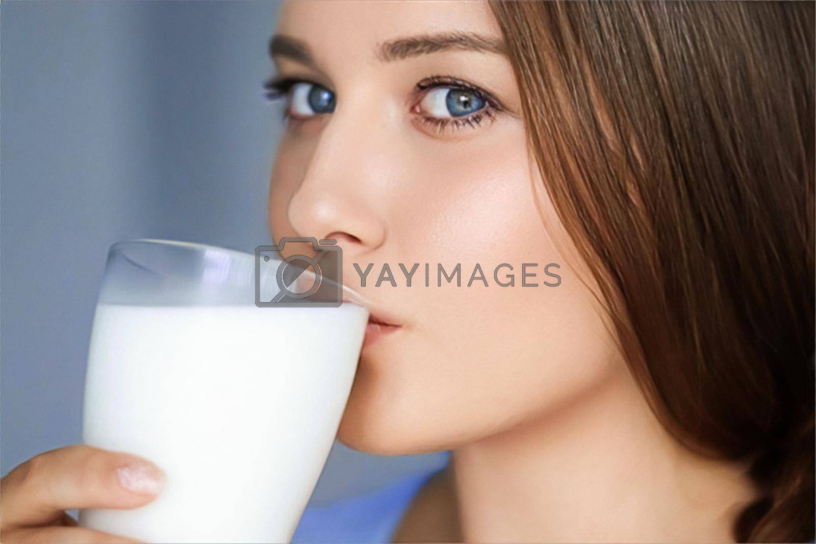 Royalty free image of Happy young woman drinking milk or protein cocktail from glass, healthy drink, diet and wellness by Anneleven