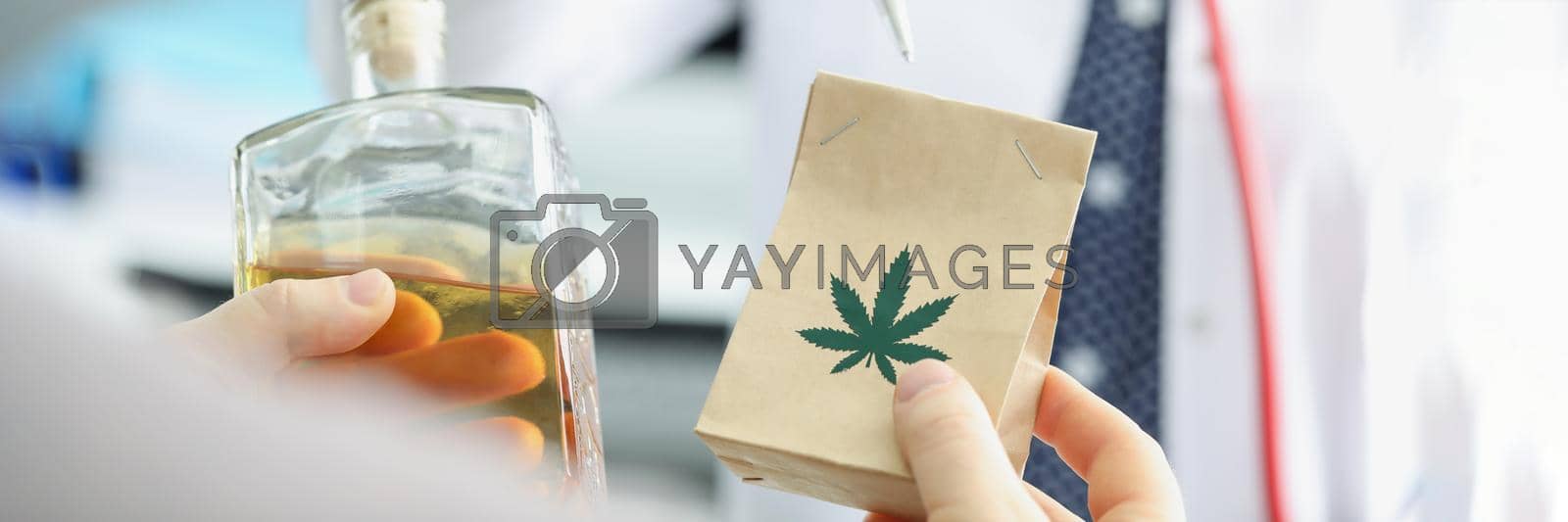 Royalty free image of Female doctor explain benefit from marijuana to her patient by kuprevich