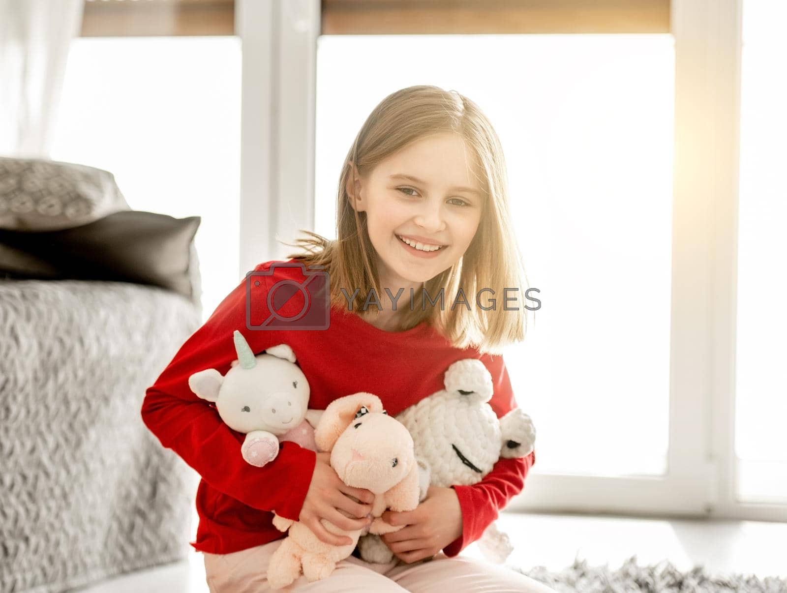 Royalty free image of Girl with toys in bedroom by tan4ikk1