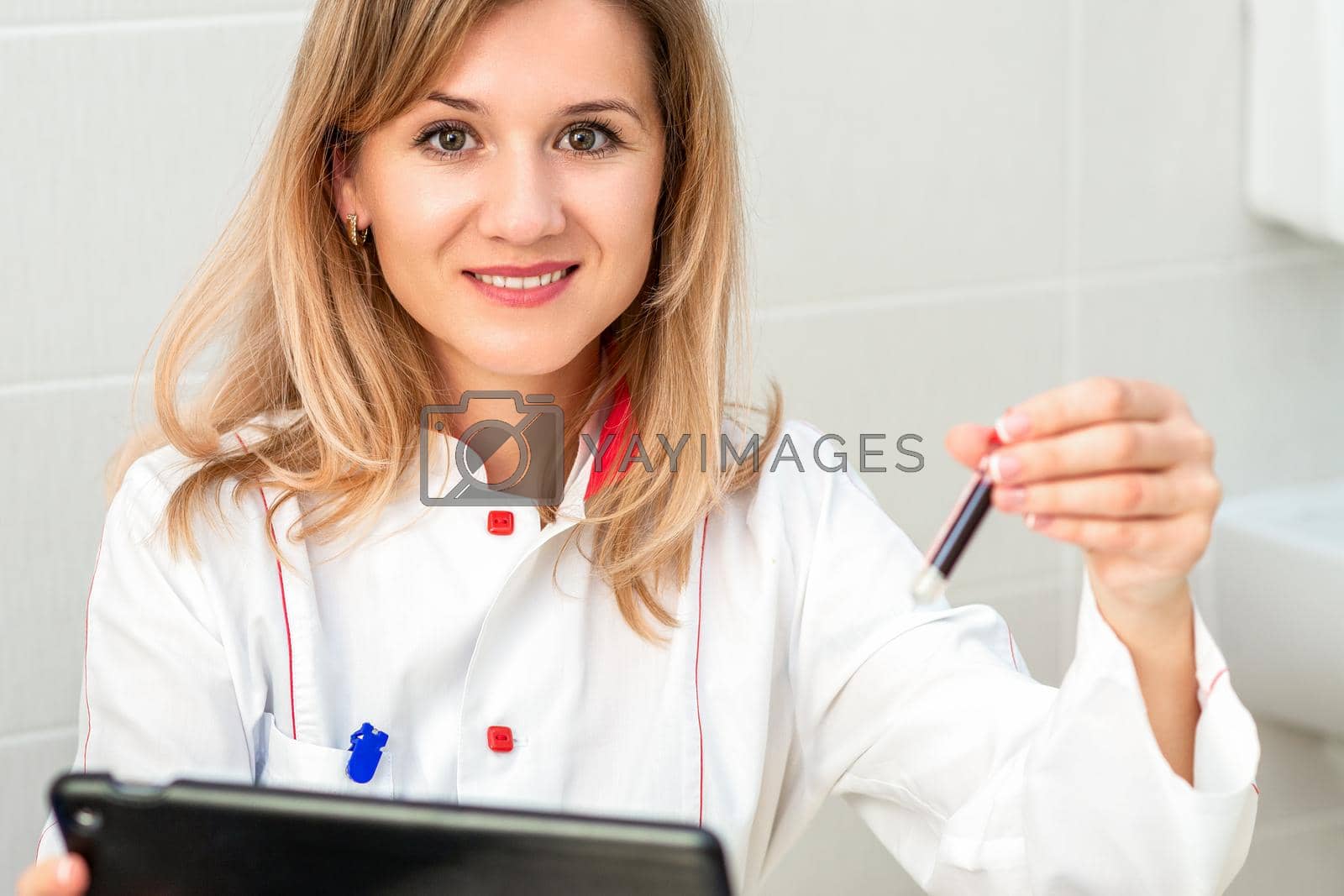 Royalty free image of Nurse holds test tube with blood by okskukuruza