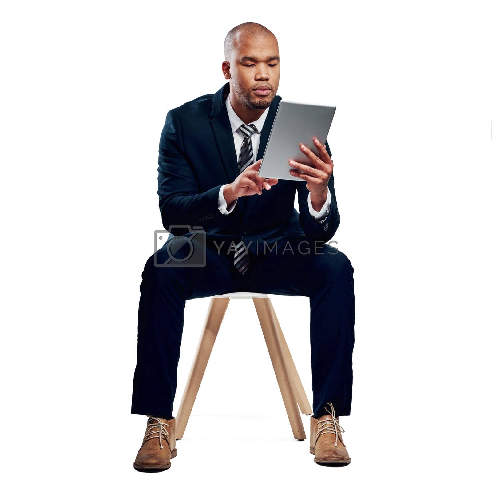 Royalty free image of Fast connectivity for the modern businessman. Studio shot of a handsome young businessman using a tablet against a white background. by YuriArcurs