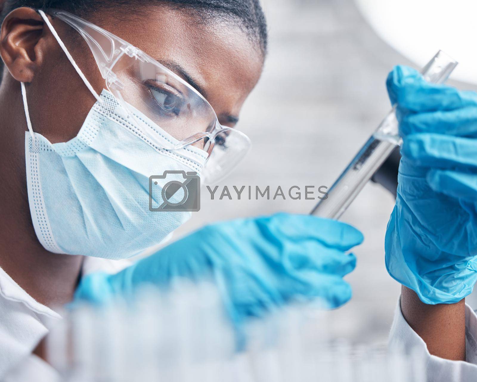 Royalty free image of Scrutinising the sample at hand. a young scientist working with test tubes in a lab. by YuriArcurs