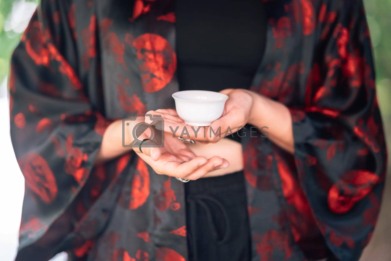 Royalty free image of Tea ceremony is performed by tea master in kimono by teksomolika