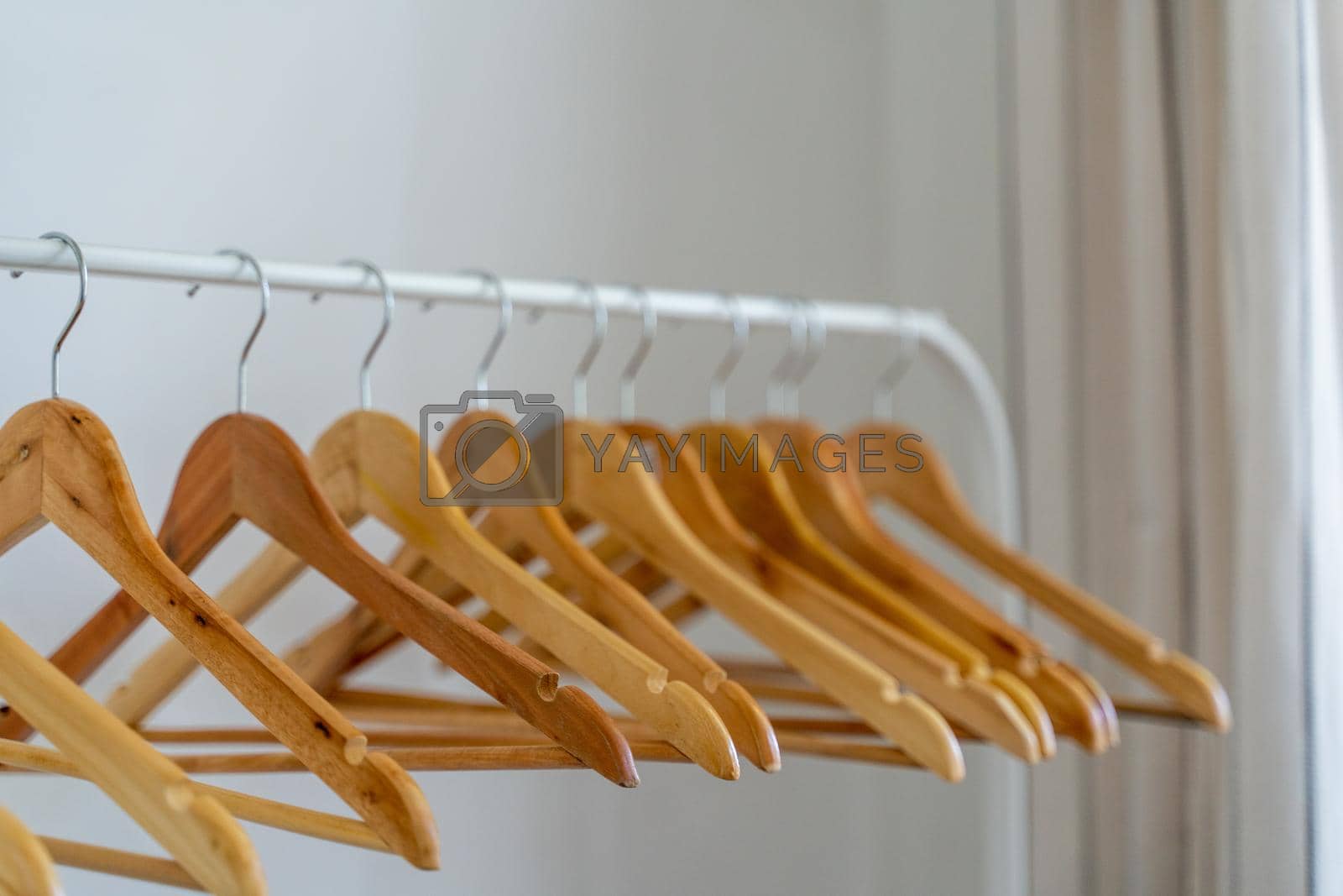 Royalty free image of Close-up of wardrobe with wooden clothes hanger, by Matiunina
