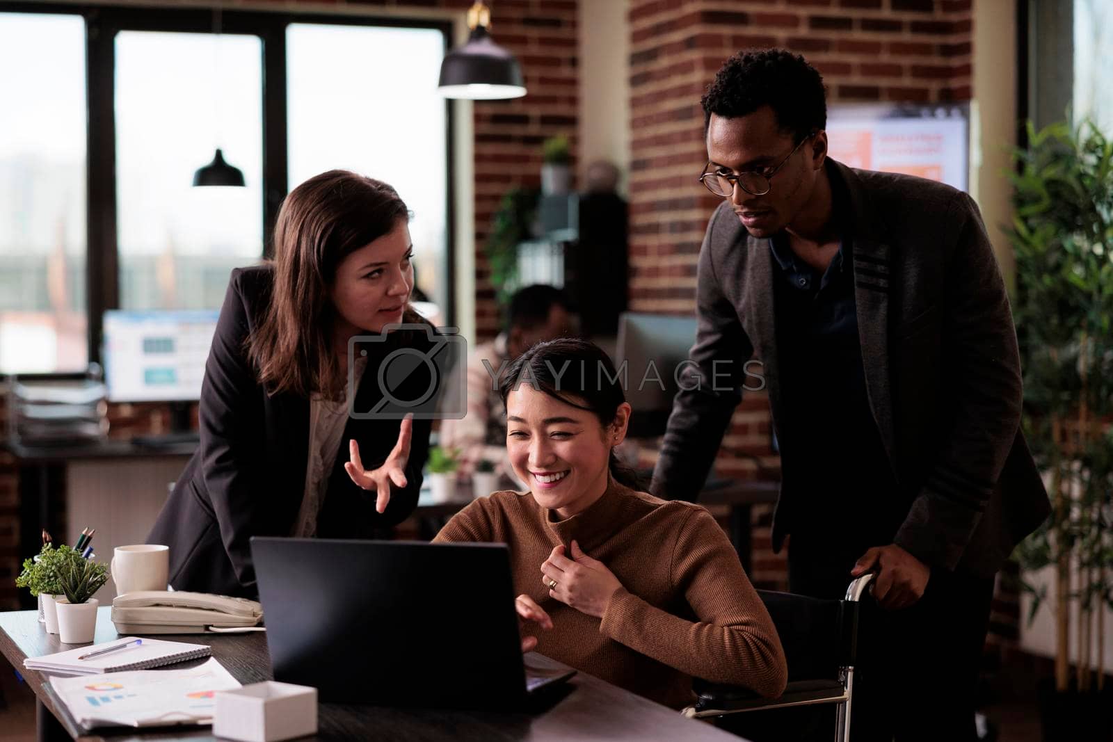 Royalty free image of Businesspeople doing startup teamwork in disability friendly office by DCStudio