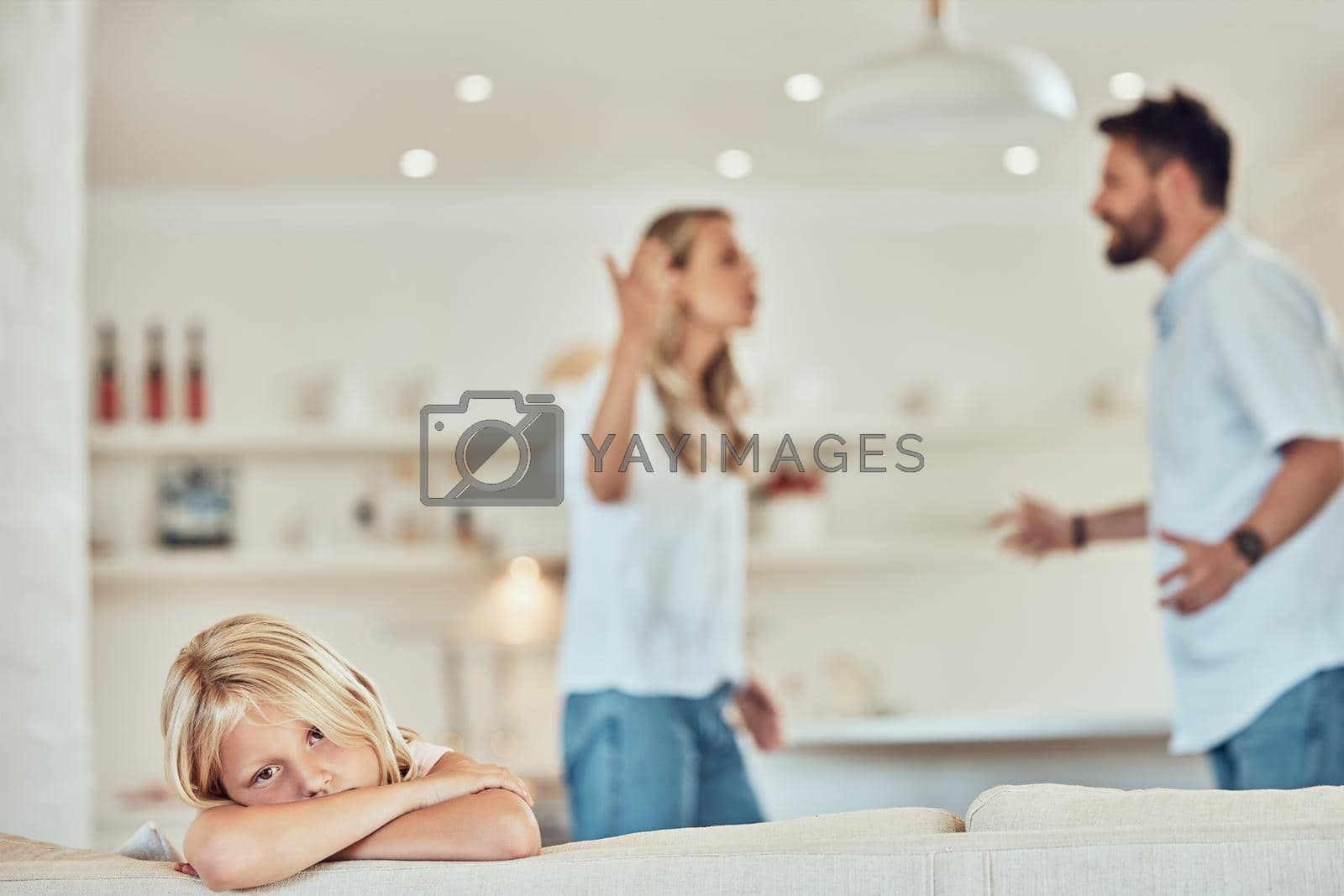 Royalty free image of Portrait of sad little girl, parents fighting in the background. Depressed child, parents arguing at home. Couple in conflict around their daughter. Stressed caucasian girl parents divorcing by YuriArcurs
