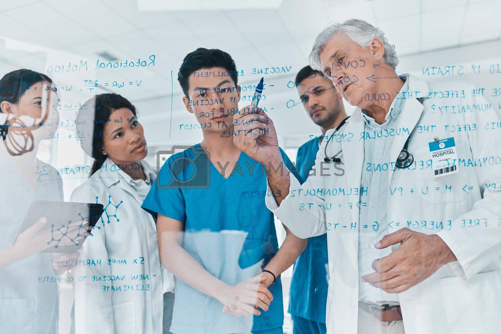 Royalty free image of Its our duty to ensure this virus is contained. a group of medical practitioners brainstorming with notes on a glass wall in a medical office. by YuriArcurs