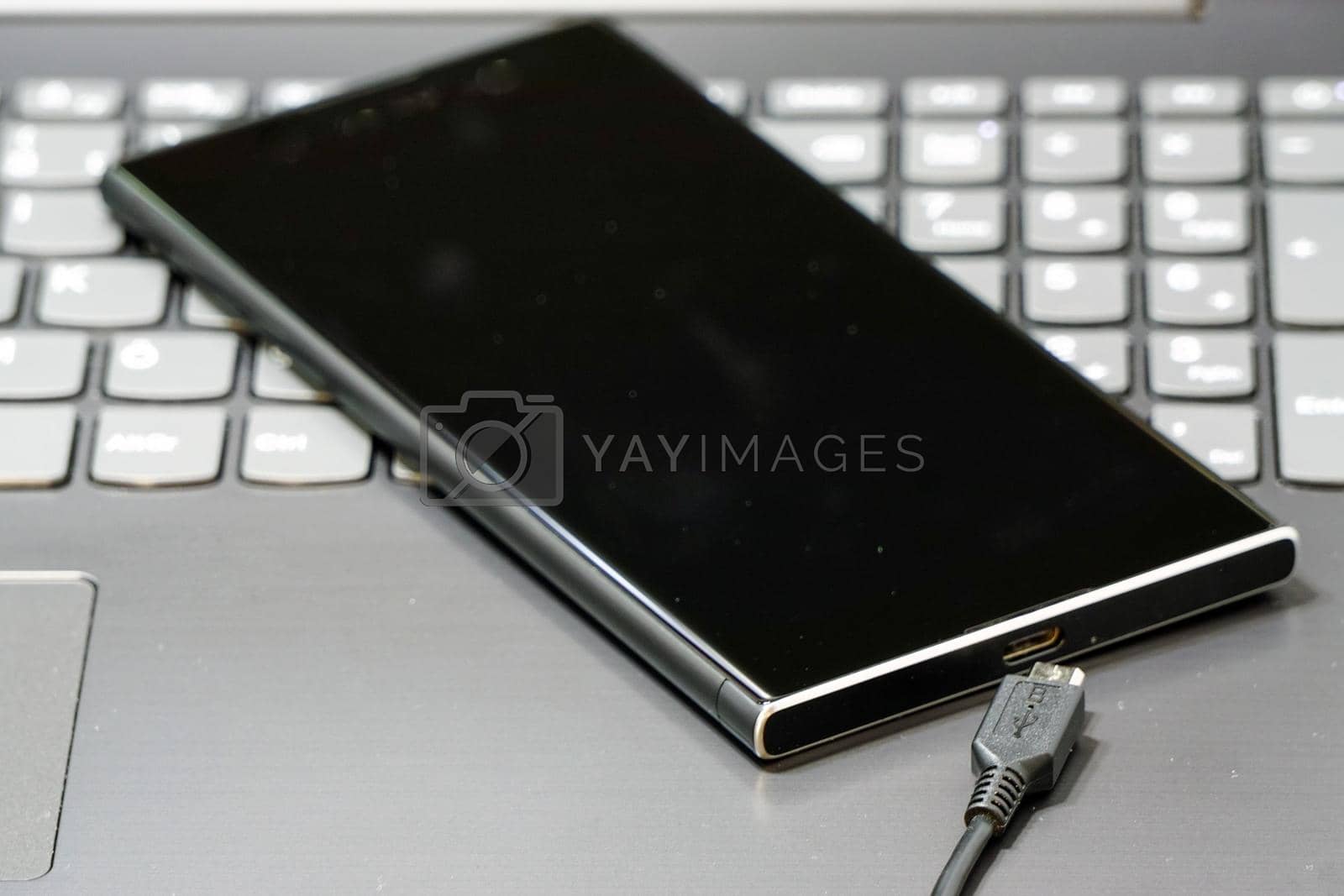 Royalty free image of Smartphone on the laptop keyboard by tasci