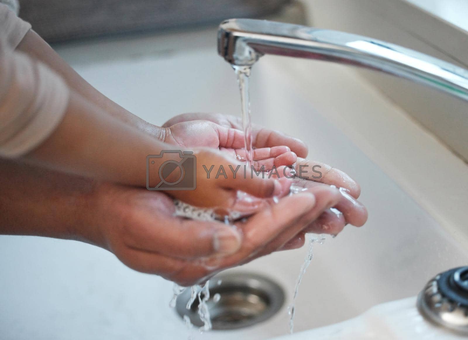 Royalty free image of Ten out of ten for washing your hands. an unrecognisable man helping his child wash their hands in the sink at home. by YuriArcurs