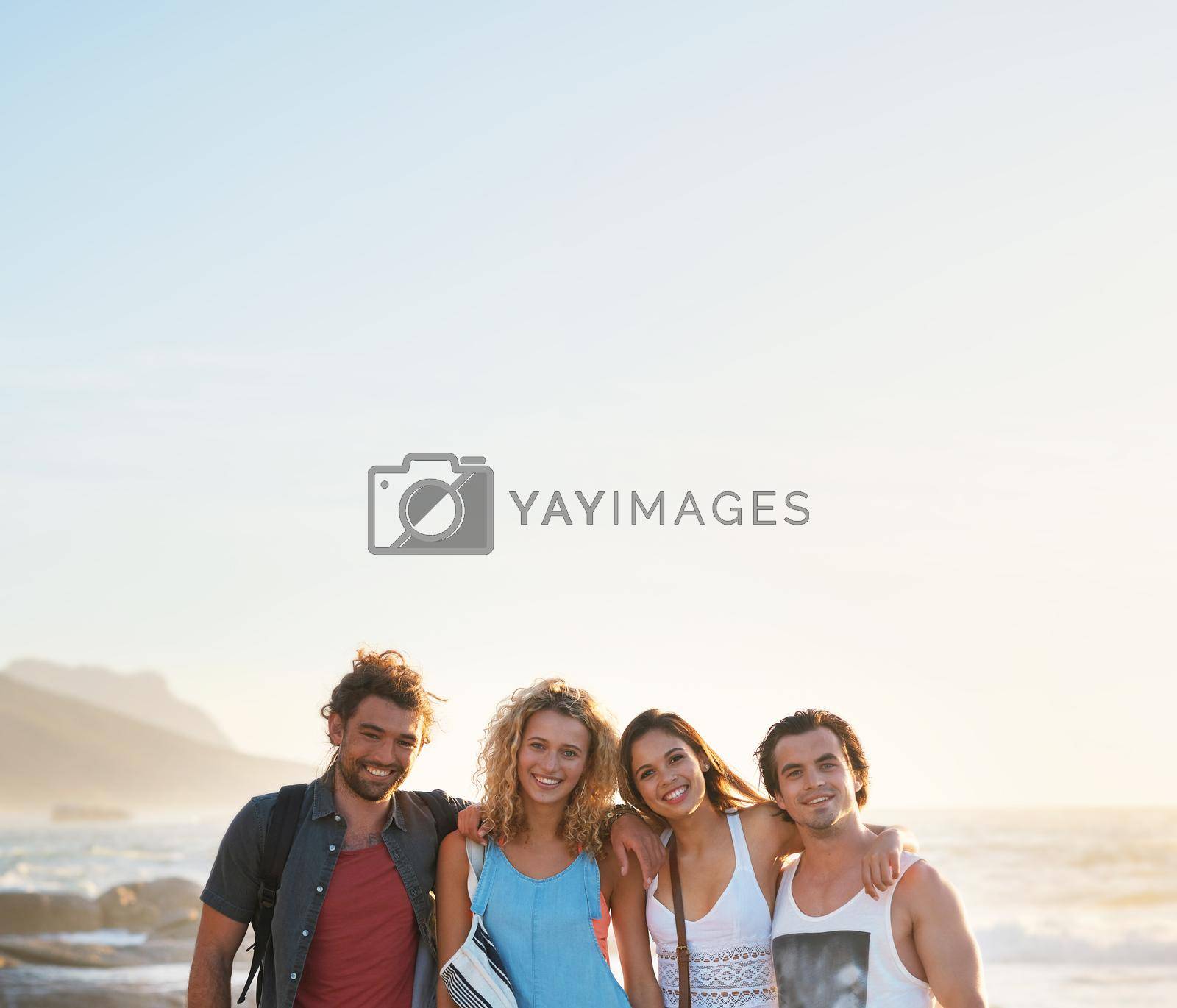 group of friends posing on beach having fun summer vacation lifestyle on seaside at sunset.