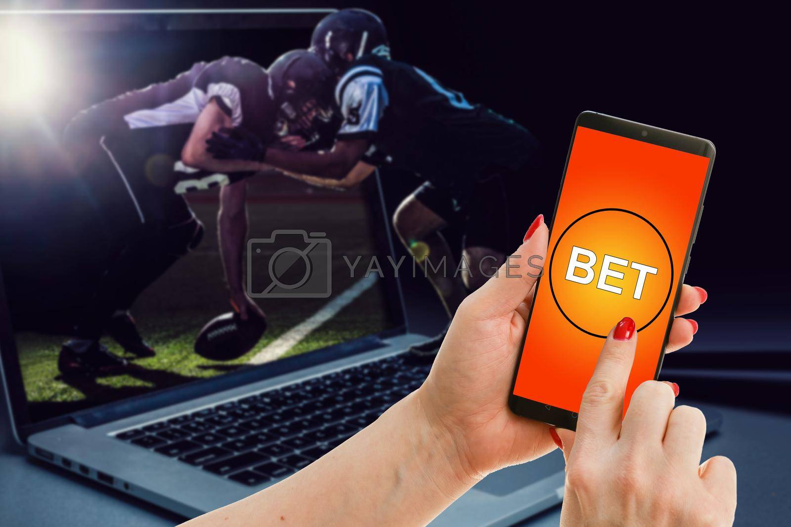 Royalty free image of a mobile phone shows a betting application with live results and updates with white background. Online betting concept. by Andelov13