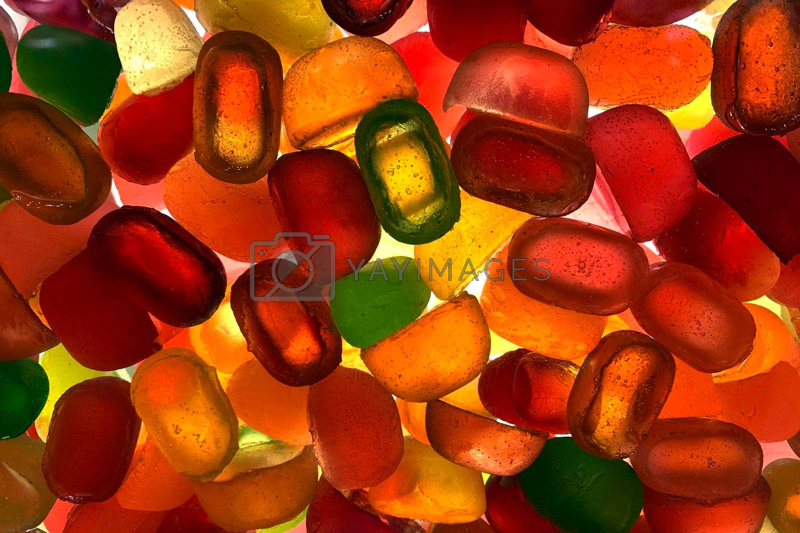 Royalty free image of Silhouette of many multi colored yummy bright candies in different shapes. by Khosro1