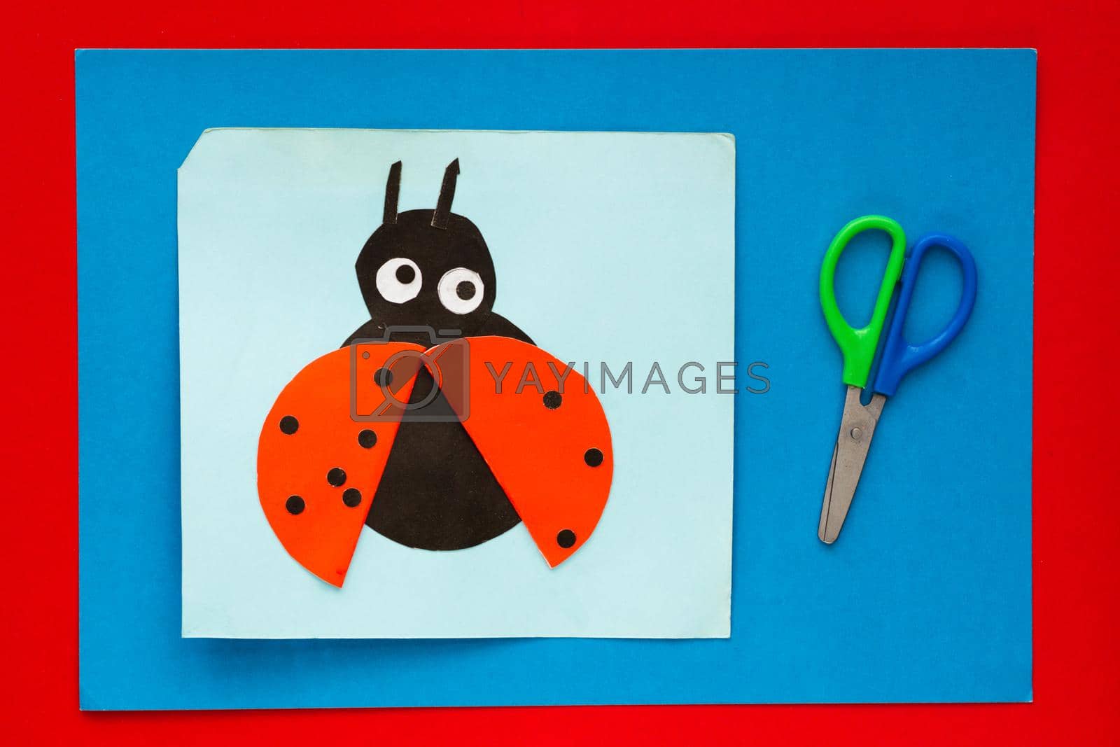 Royalty free image of Ladybug made from paper by child on multicolor sheets background by TatianaFoxy