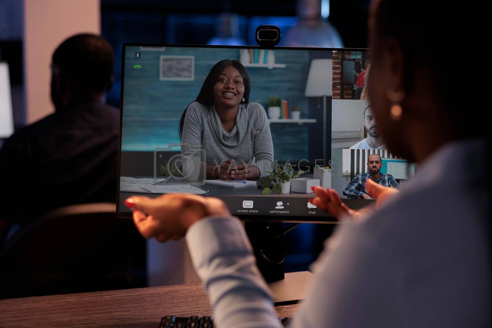 Royalty free image of Company worker talking to colleagues on remote videoconference by DCStudio