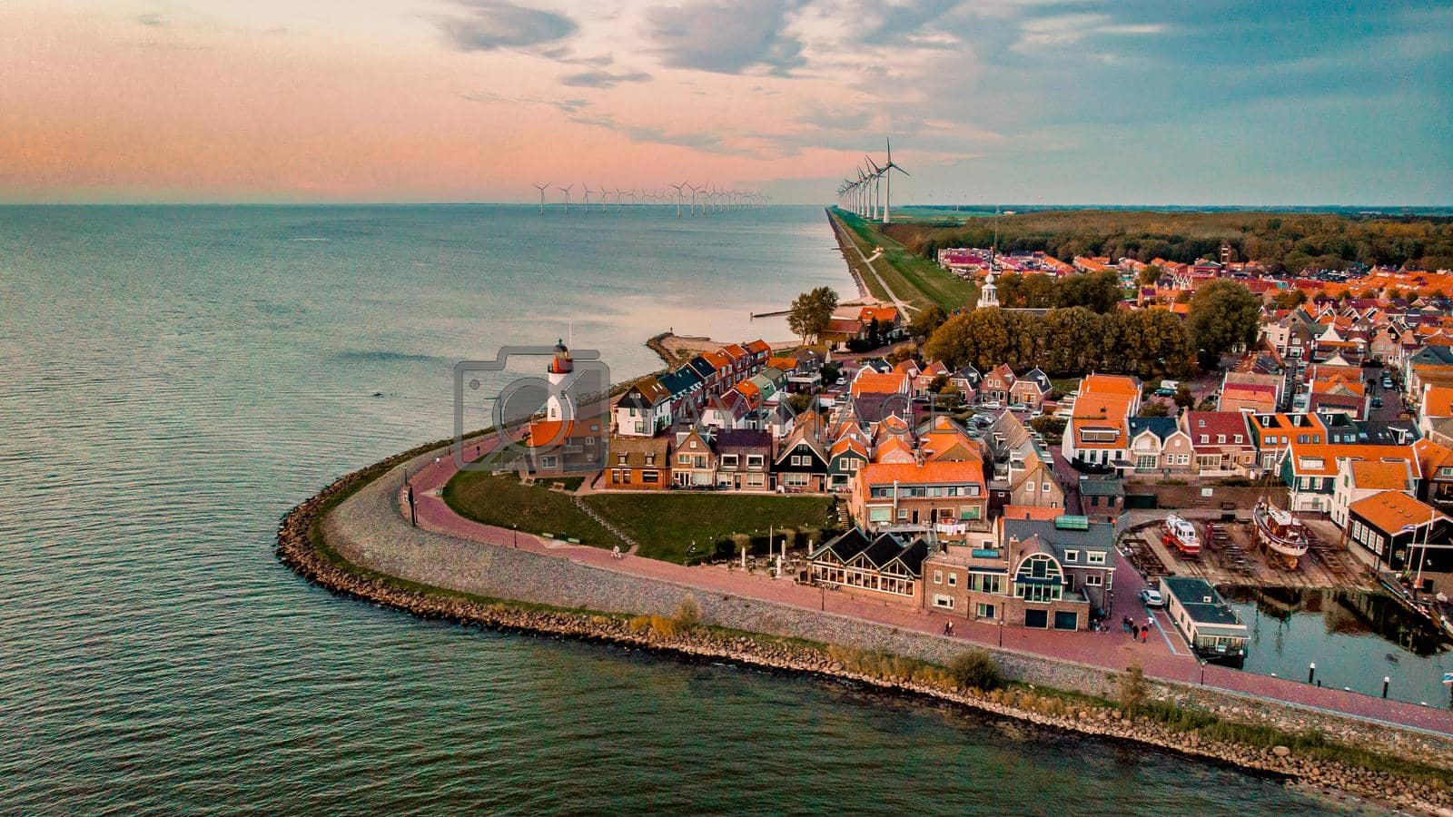Royalty free image of Urk Flevoland Netherlands sunset at the lighthouse and harbor of Urk Holland. Fishing village Urk by fokkebok