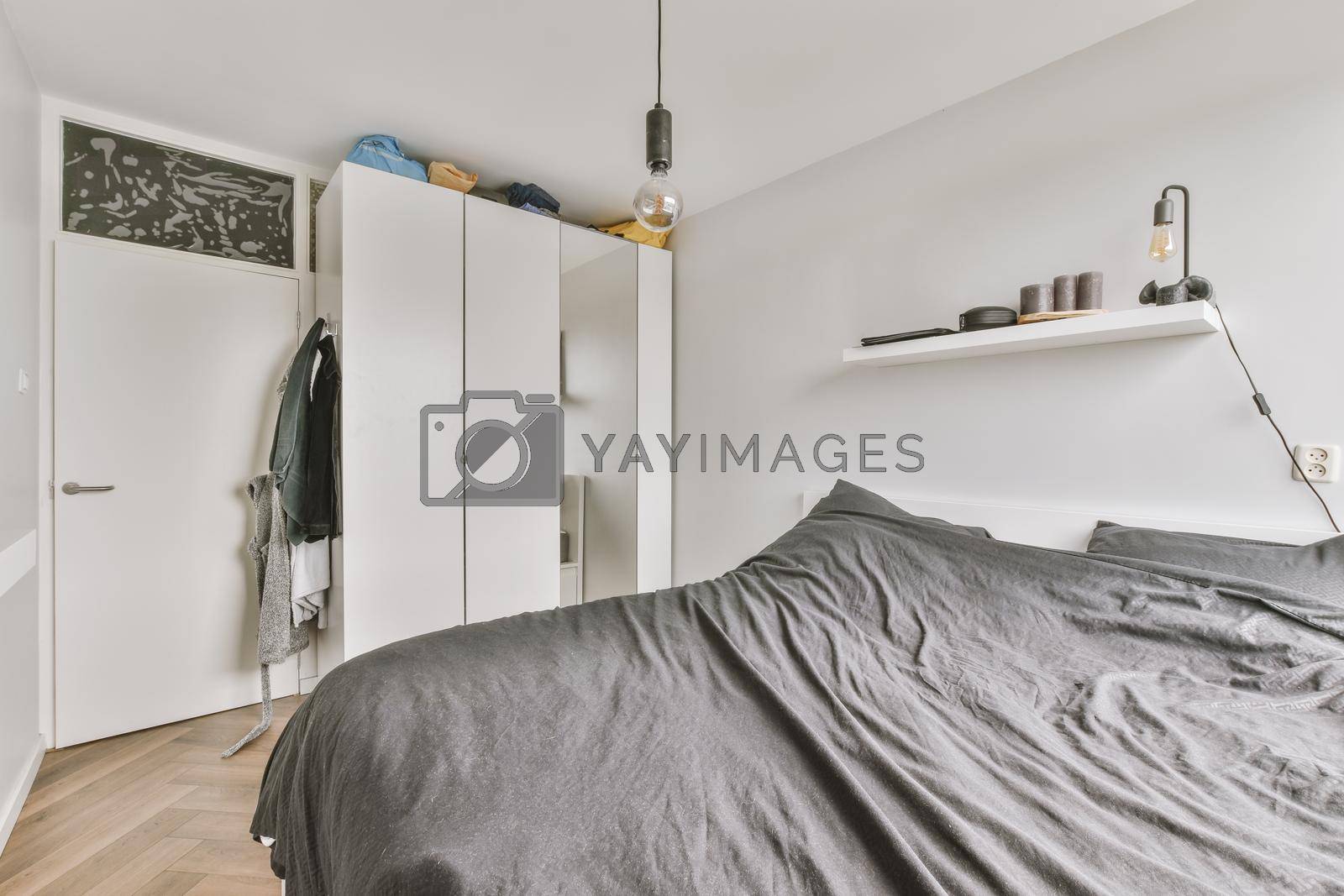 Royalty free image of Light bedroom with wooden wardrobe by casamedia