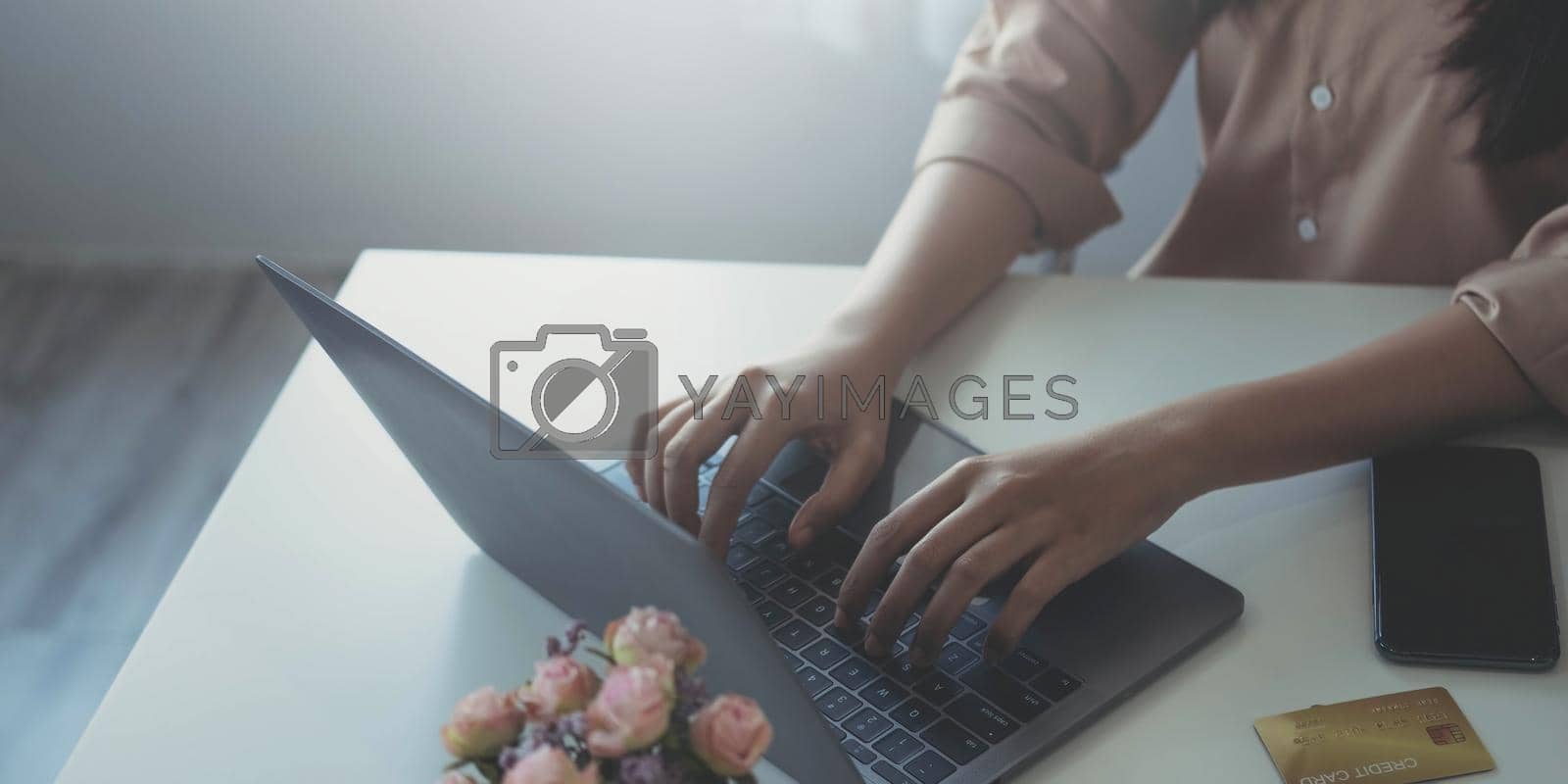 Royalty free image of Businesswoman using laptop computer keyboard at the office. by wichayada