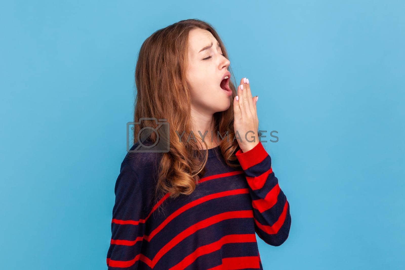 Royalty free image of Woman yawning and covering mouth with palm, lack of sleep, fatigue concept. by Khosro1