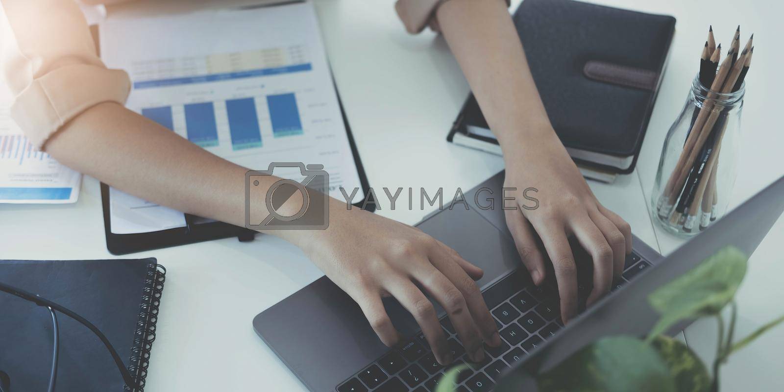 Royalty free image of Business woman sitting using laptop computer with on the desk in the office. by wichayada