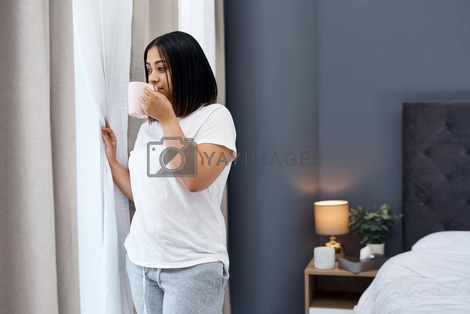 Royalty free image of A cup of coffee get the day started. a young woman having coffee in the morning at home. by YuriArcurs