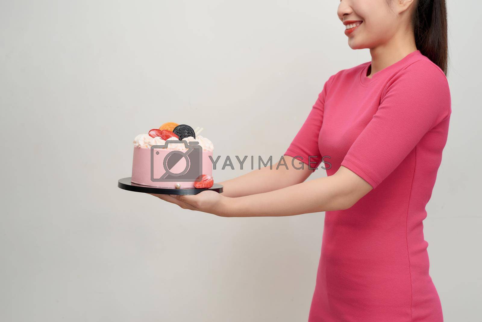 Royalty free image of Woman holds birthday cake in her hands by makidotvn