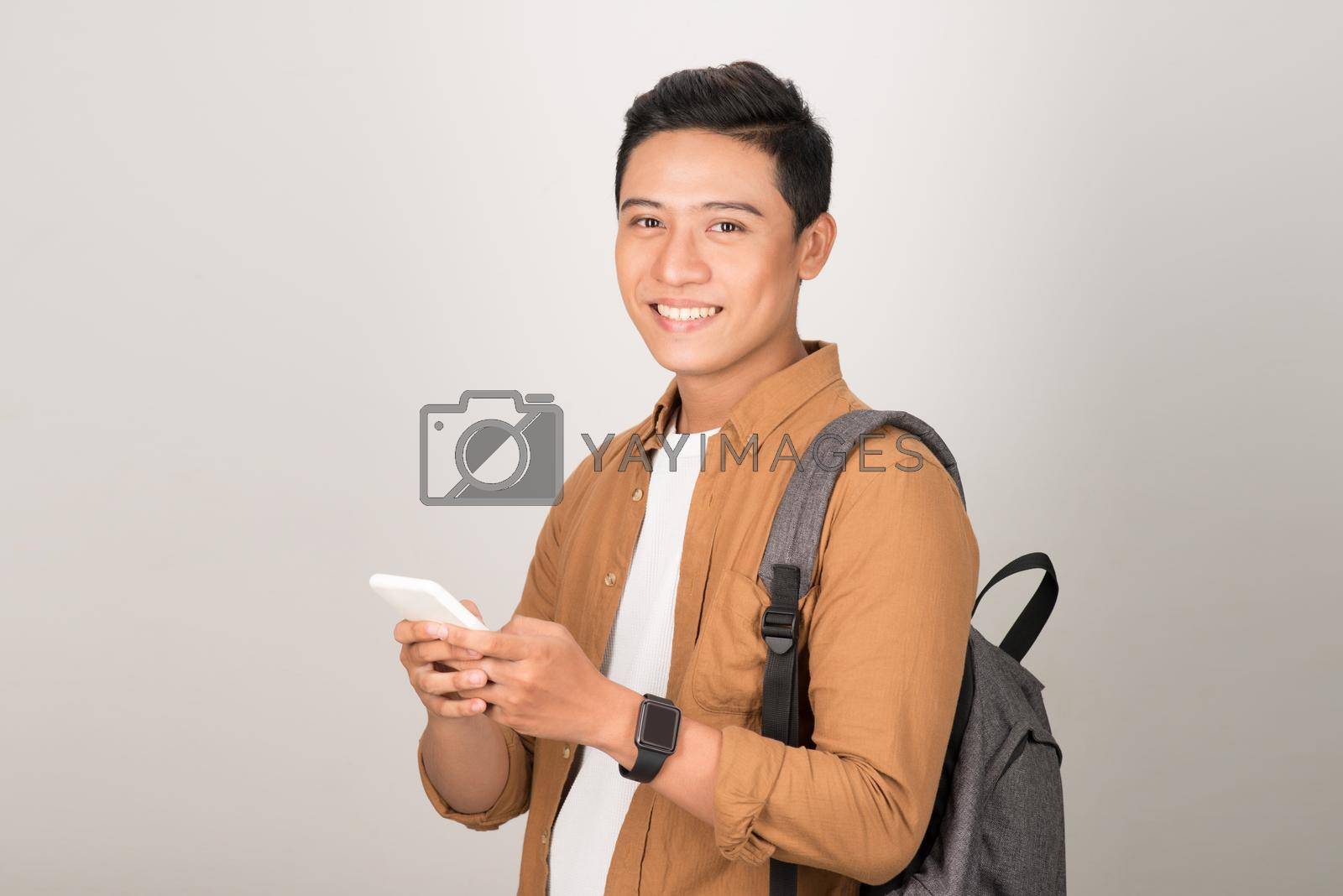 Royalty free image of Young Asian Student Texting on Cell Phone Isolated on White Background by makidotvn