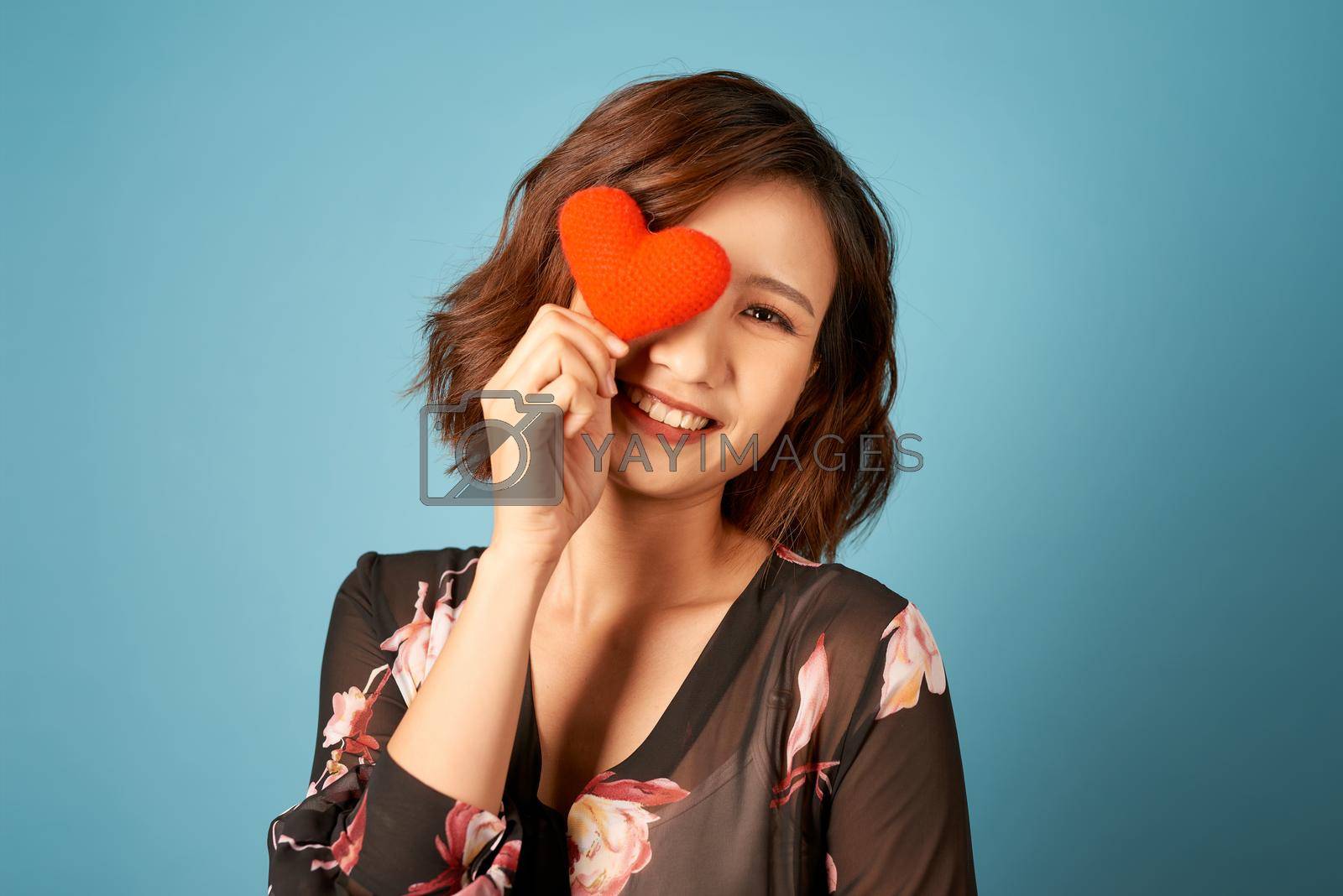 Royalty free image of Picture of beautiful woman covering eye with heart by makidotvn