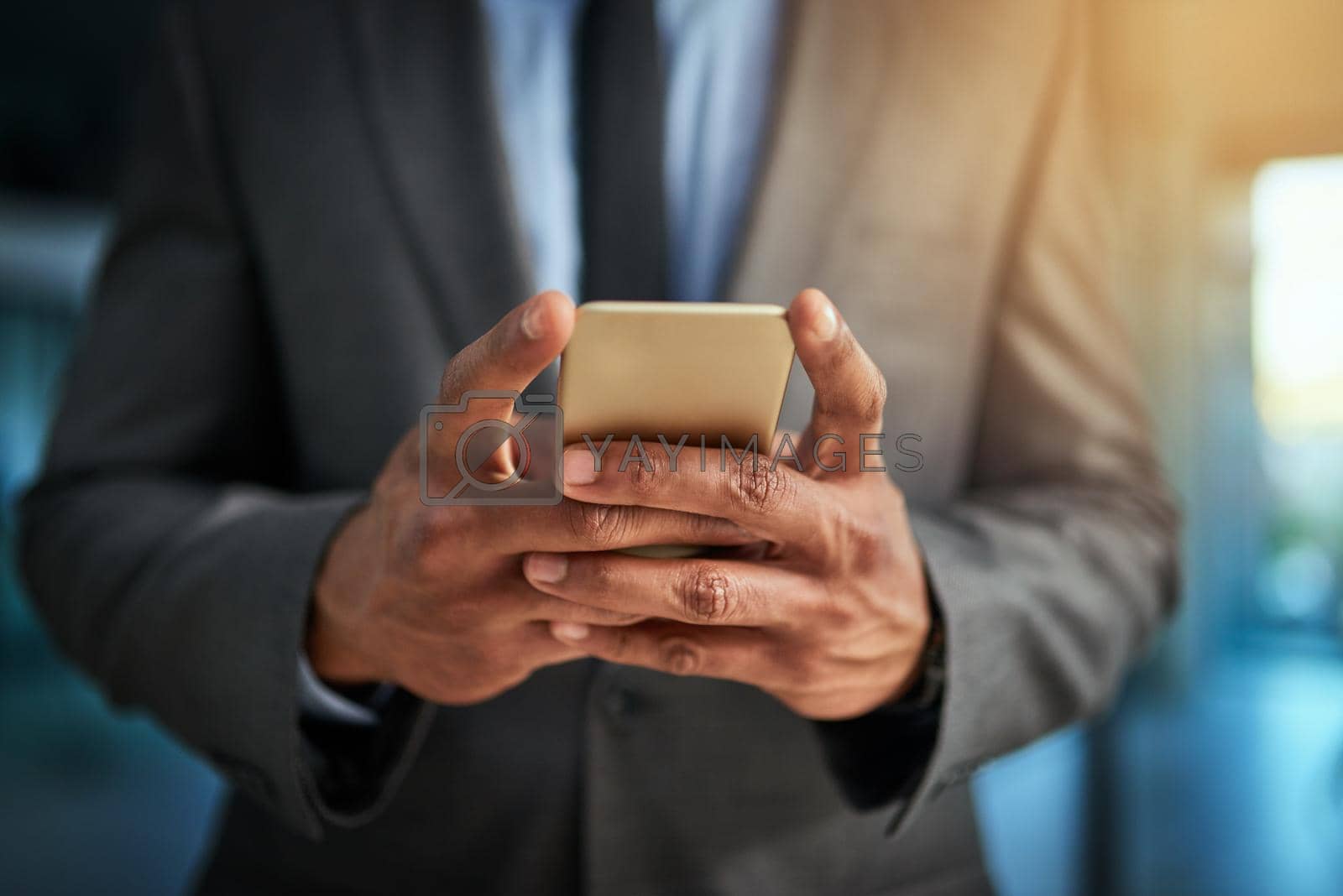 Royalty free image of Business man browsing the internet on his phone texting and posting on social media. Closeup of a male entrepreneur browsing or searching a website or web for news or clickbait by YuriArcurs