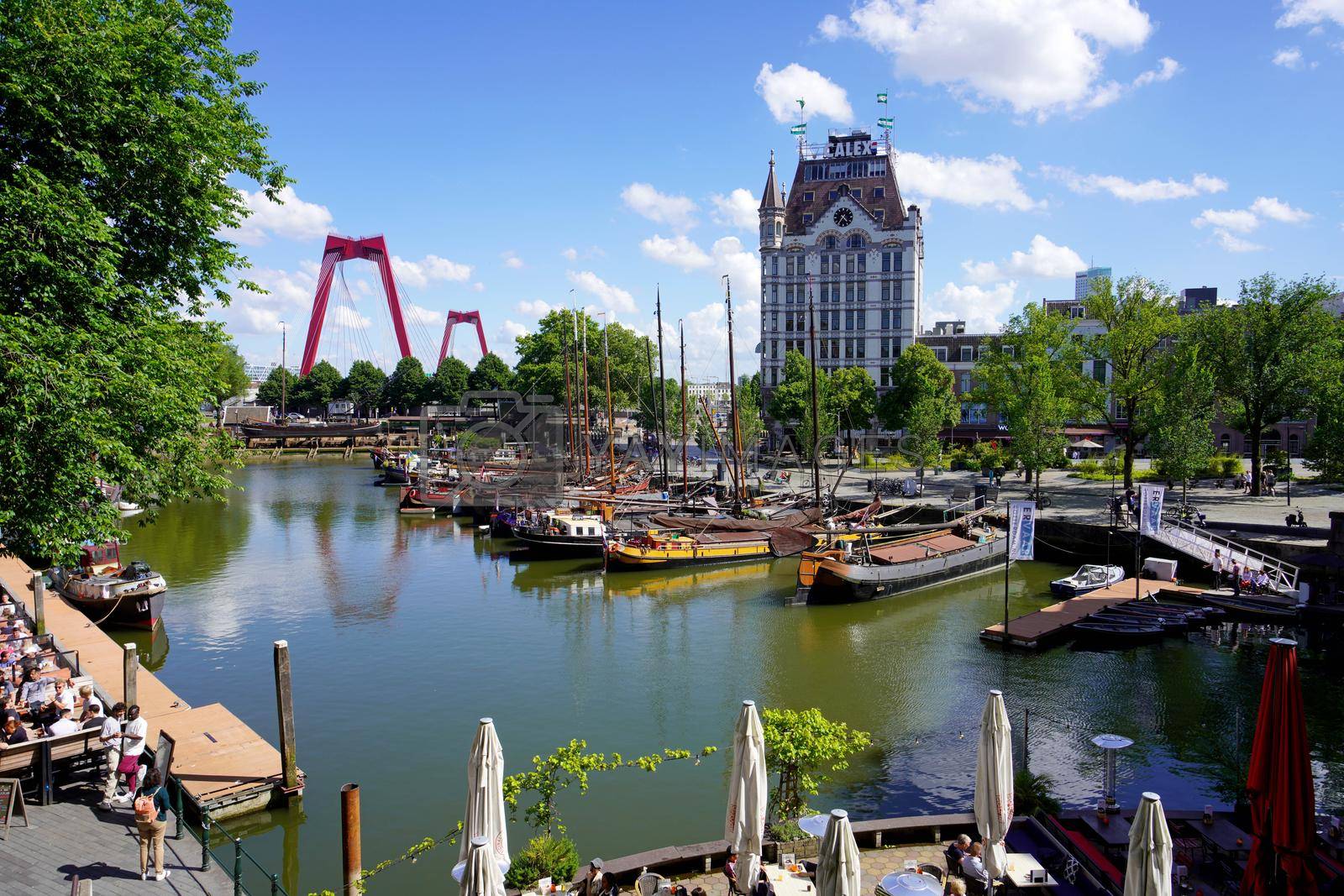 ROTTERDAM, NETHERLANDS - JUNE 9, 2022: Oude Haven, one of the oldest ports of Rotterdam with Witte Huis building and Willemsbrug bridge, Netherlands