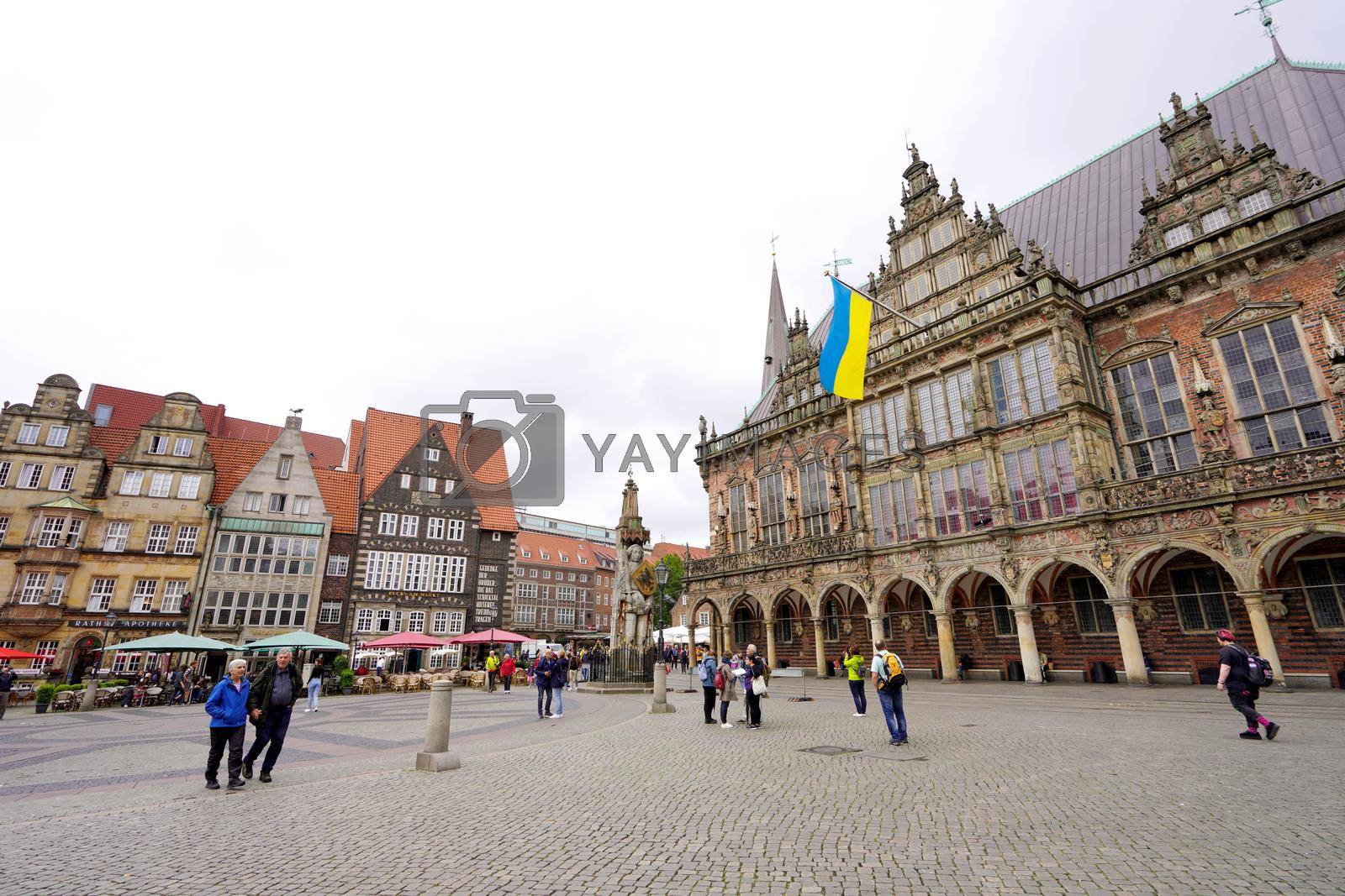 BREMEN, GERMANY - JULY, 7 2022: Bremen City Hall with Ukrainian flag during Russian invasion in Ukraine