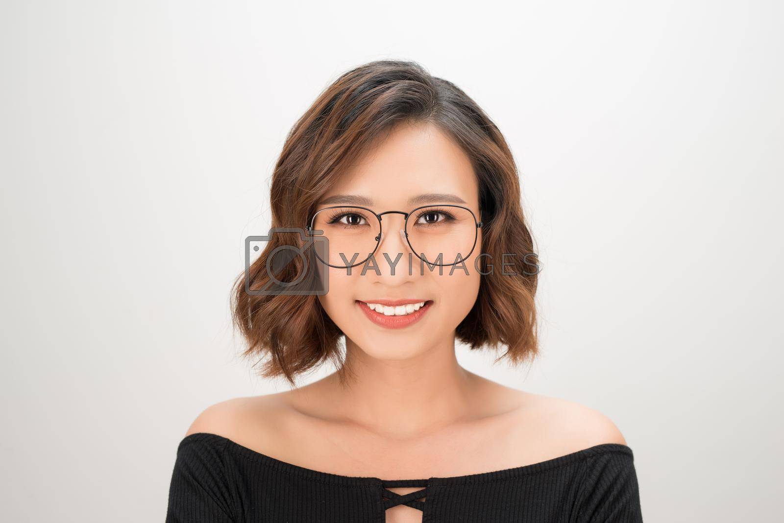 Royalty free image of Portrait of young Asian smiley woman wearing glasses over white background by makidotvn