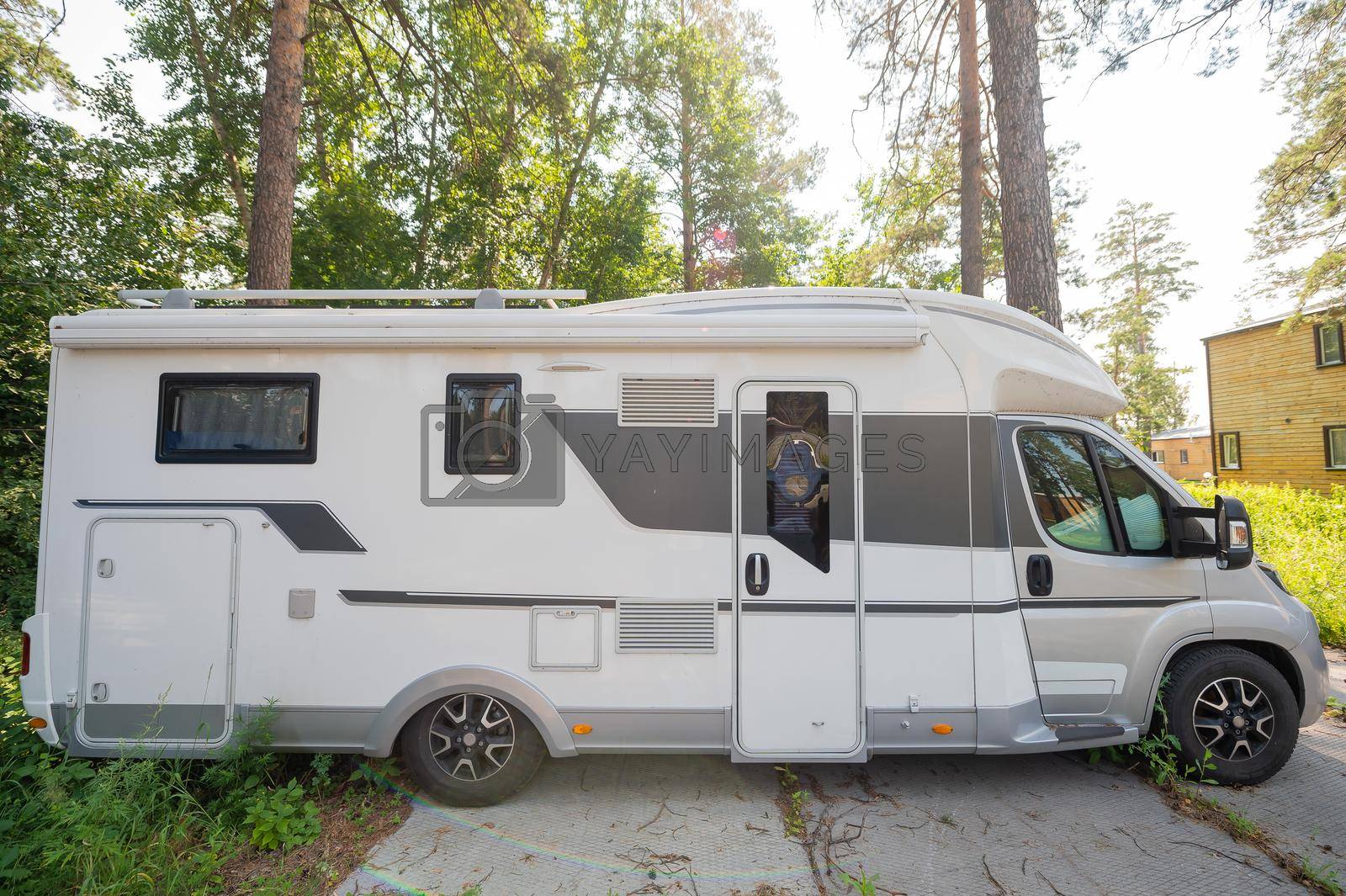 17 july 2020, Russia, Novosibirsk: A white mobile home is parked in the woods. Caravan for life and family road travel. No people