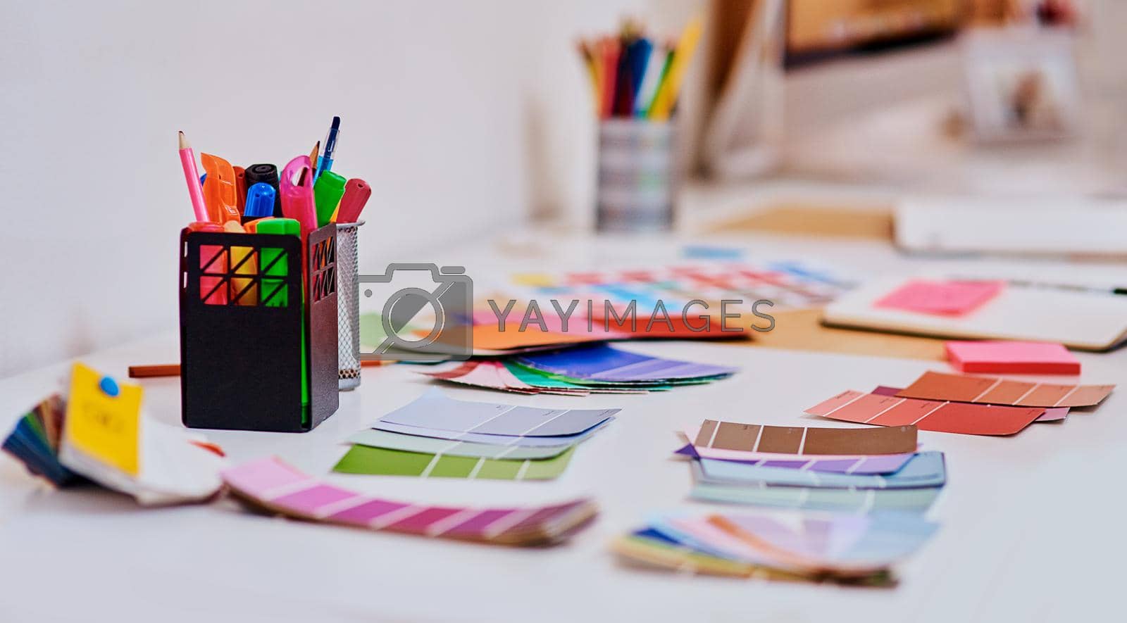 Royalty free image of Lots of colour to spark lots of creativity. a notebook and various tools at a creative workstation. by YuriArcurs