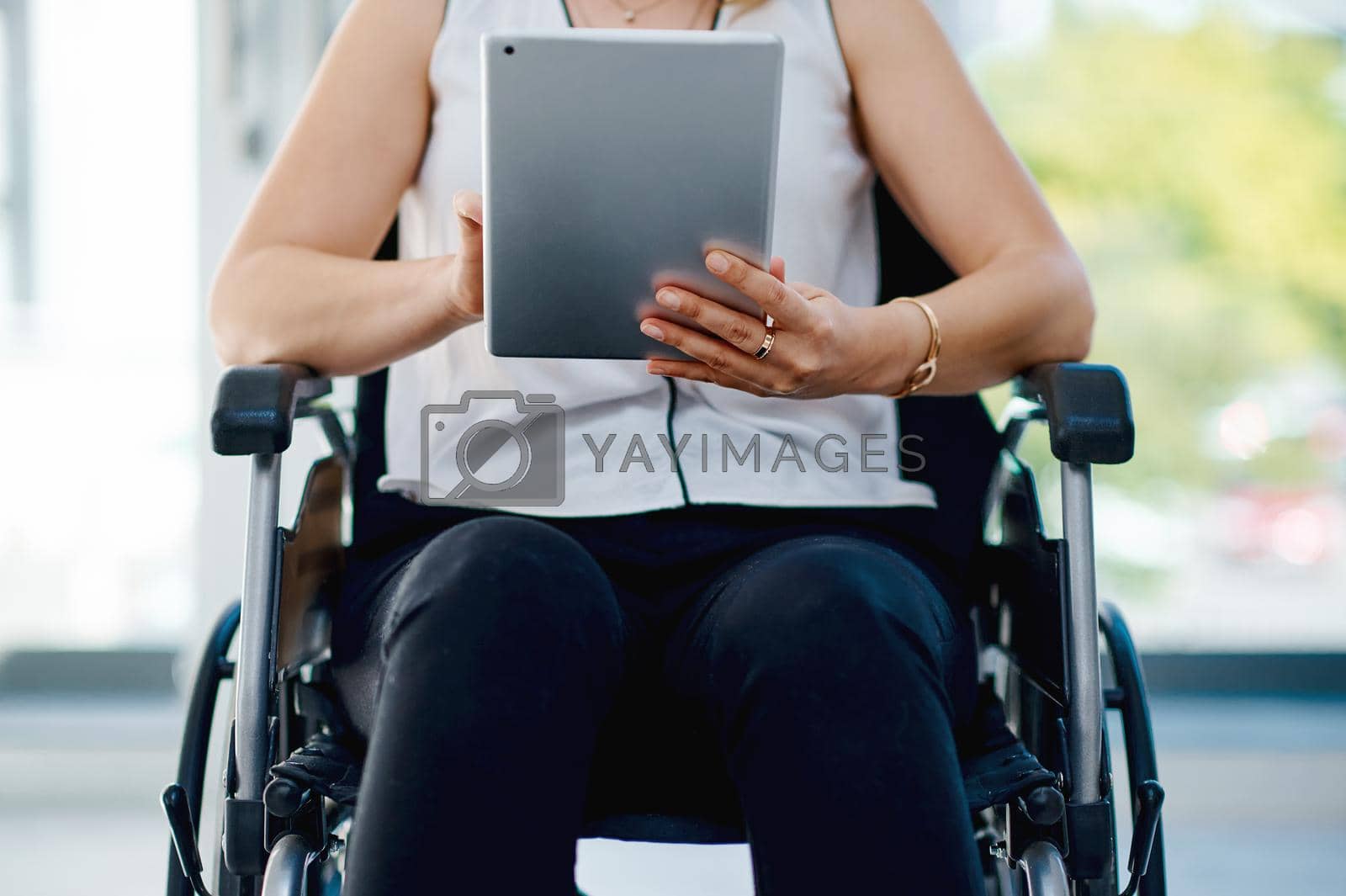 Royalty free image of Online resources makes everyones job a little easier. an unrecognizable businesswoman using a digital tablet in the office. by YuriArcurs