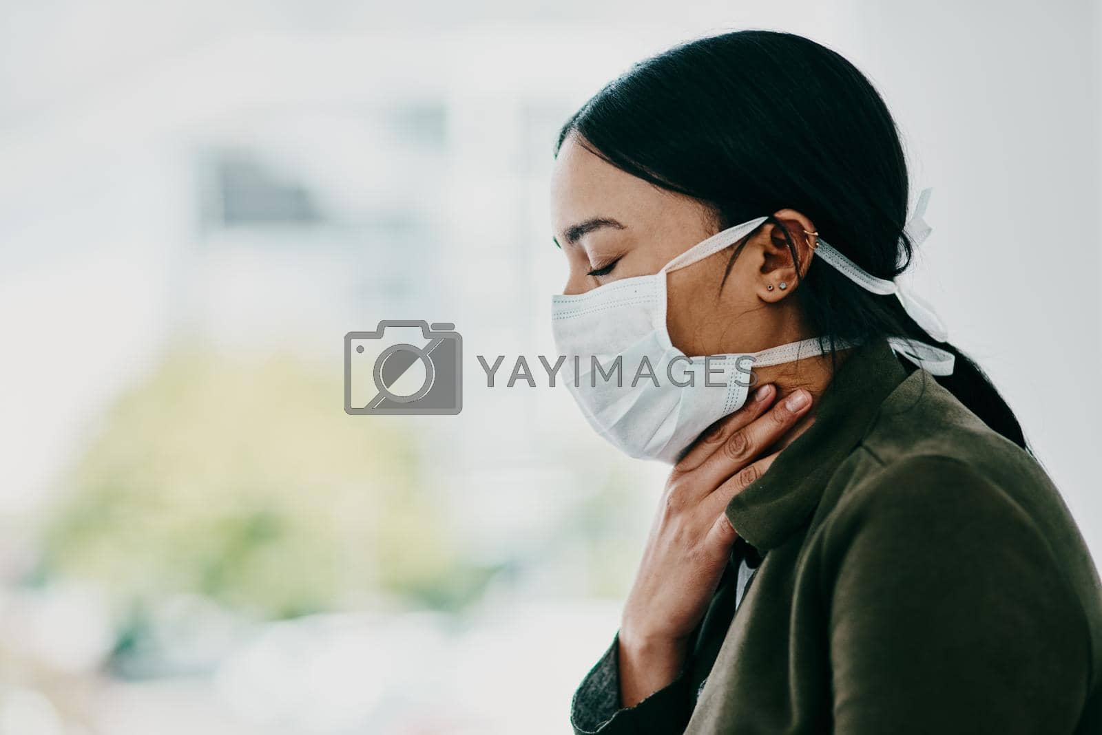 Royalty free image of Take care, Covid-19 is here. a young woman wearing a mask and suffering from throat pain in a doctors office. by YuriArcurs
