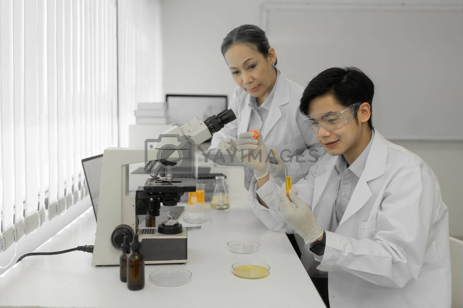 Royalty free image of Scientist holding a test tube containing cannabis extract. by itchaznong