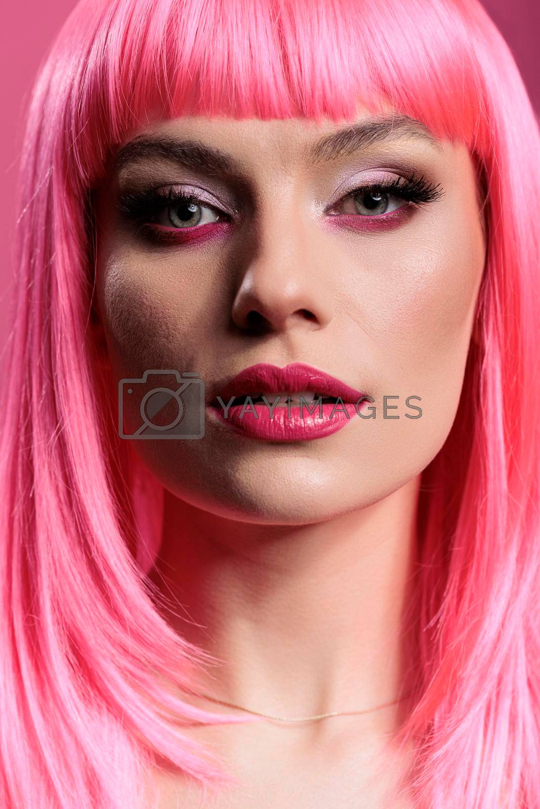 Royalty free image of Portrait of caucasian woman with sensual makeup and pink hair by DCStudio