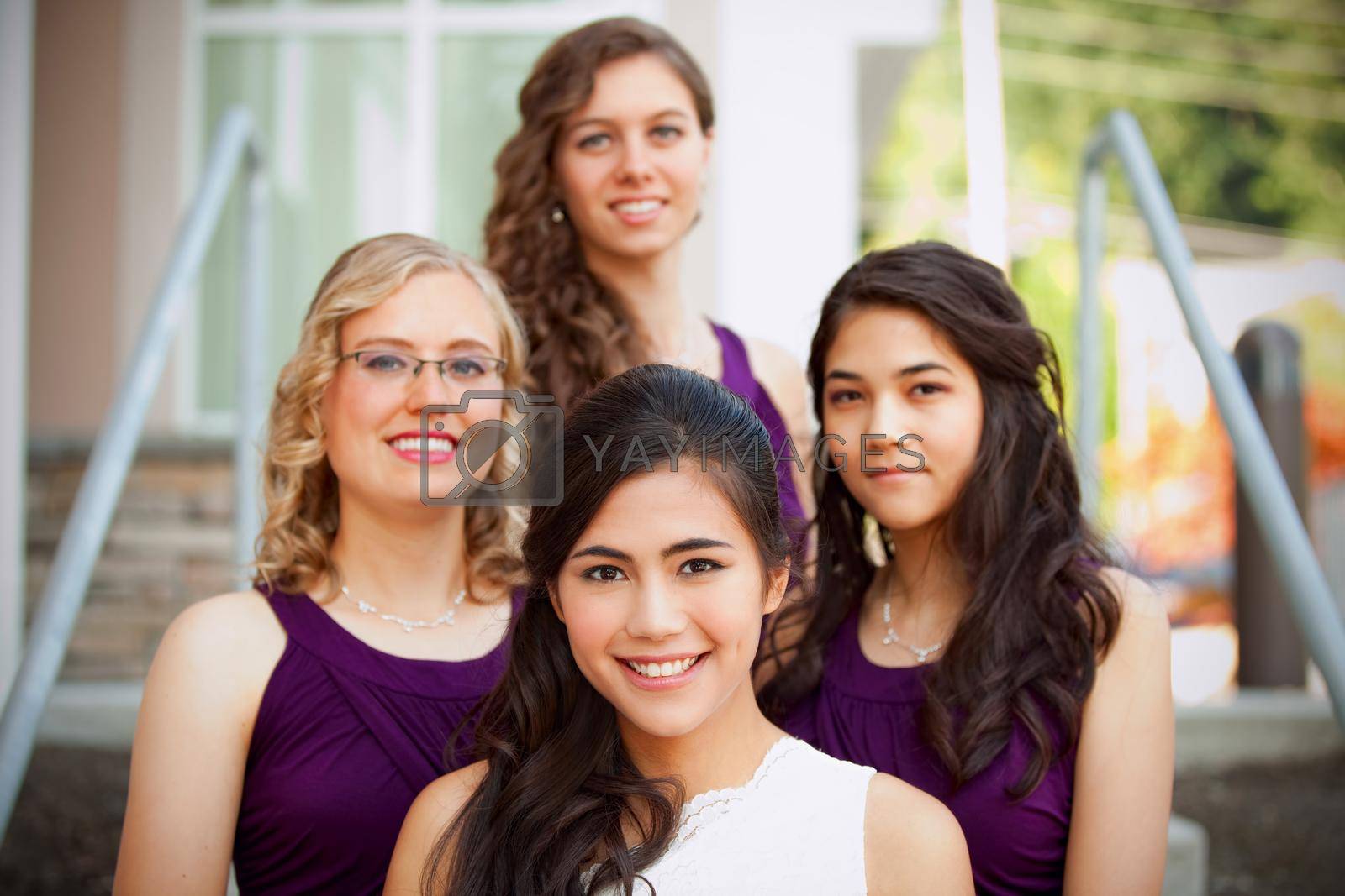 Royalty free image of Beautiful biracial young bride smiling with her multiethnic group of bridesmaids by jarenwicklund