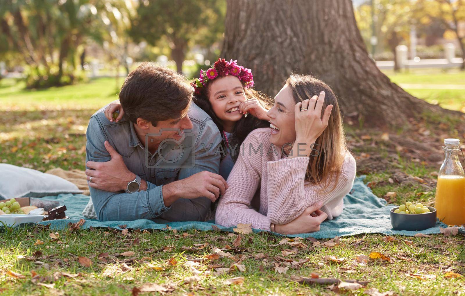Nothing says family time like a picnic in the park. a happy young family enjoying a picnic in the park