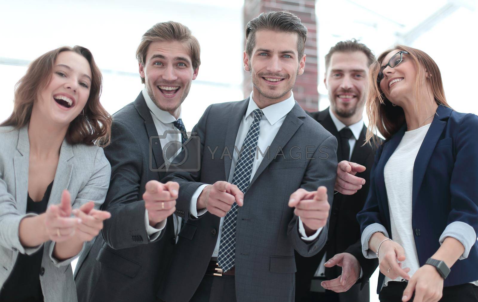 Royalty free image of A group of business people standing and pointing at you by asdf