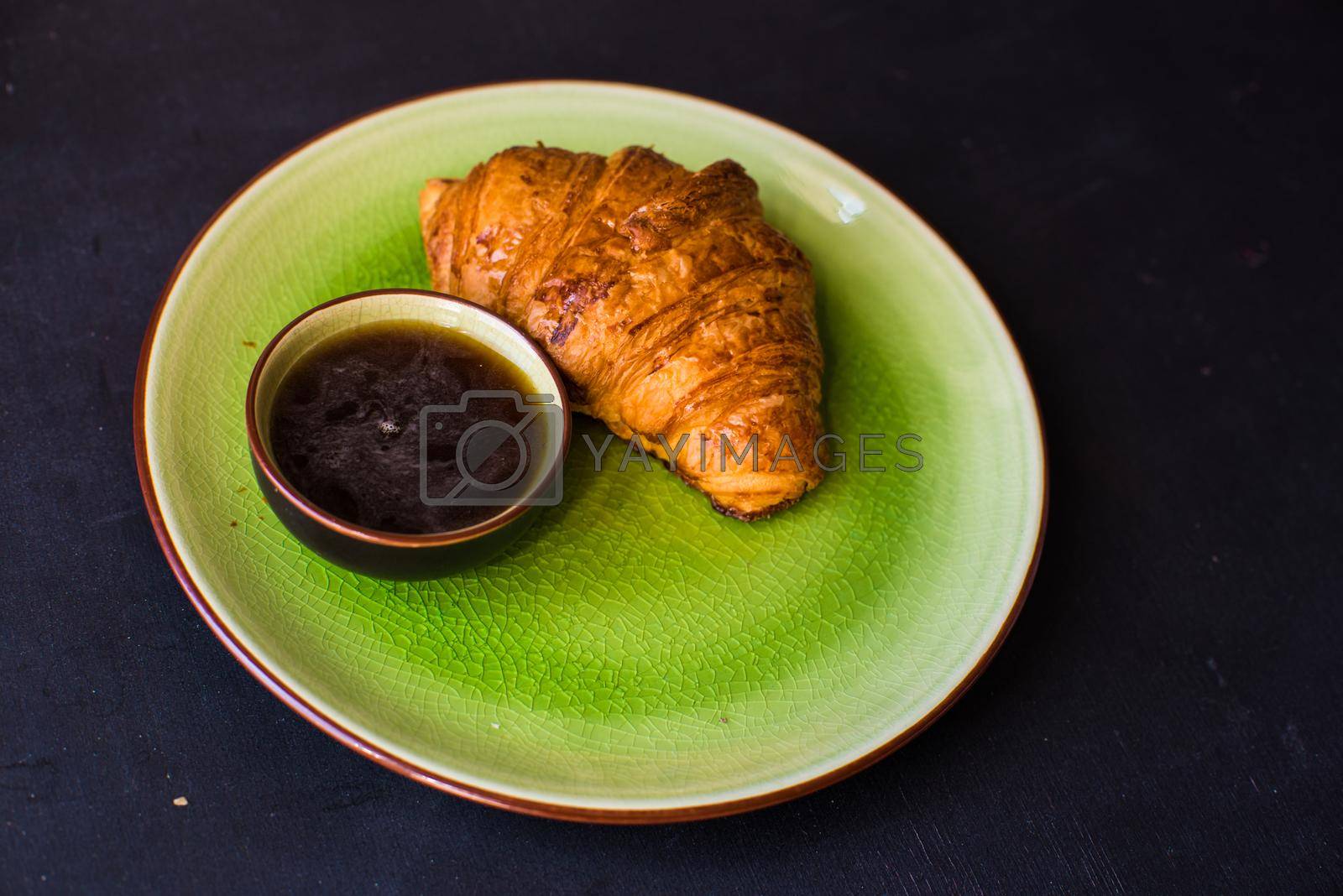 Fresh homemade french croissant on dark wooden table