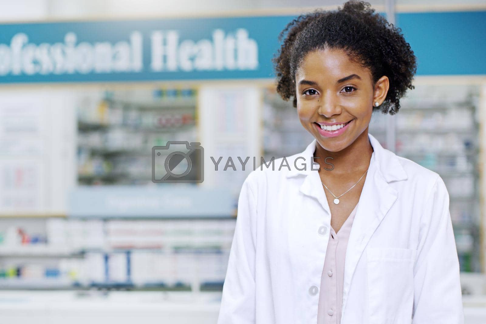Royalty free image of With us your wellbeing is the first priority. Portrait of an attractive young pharmacist smiling and posing in a pharmacy. by YuriArcurs
