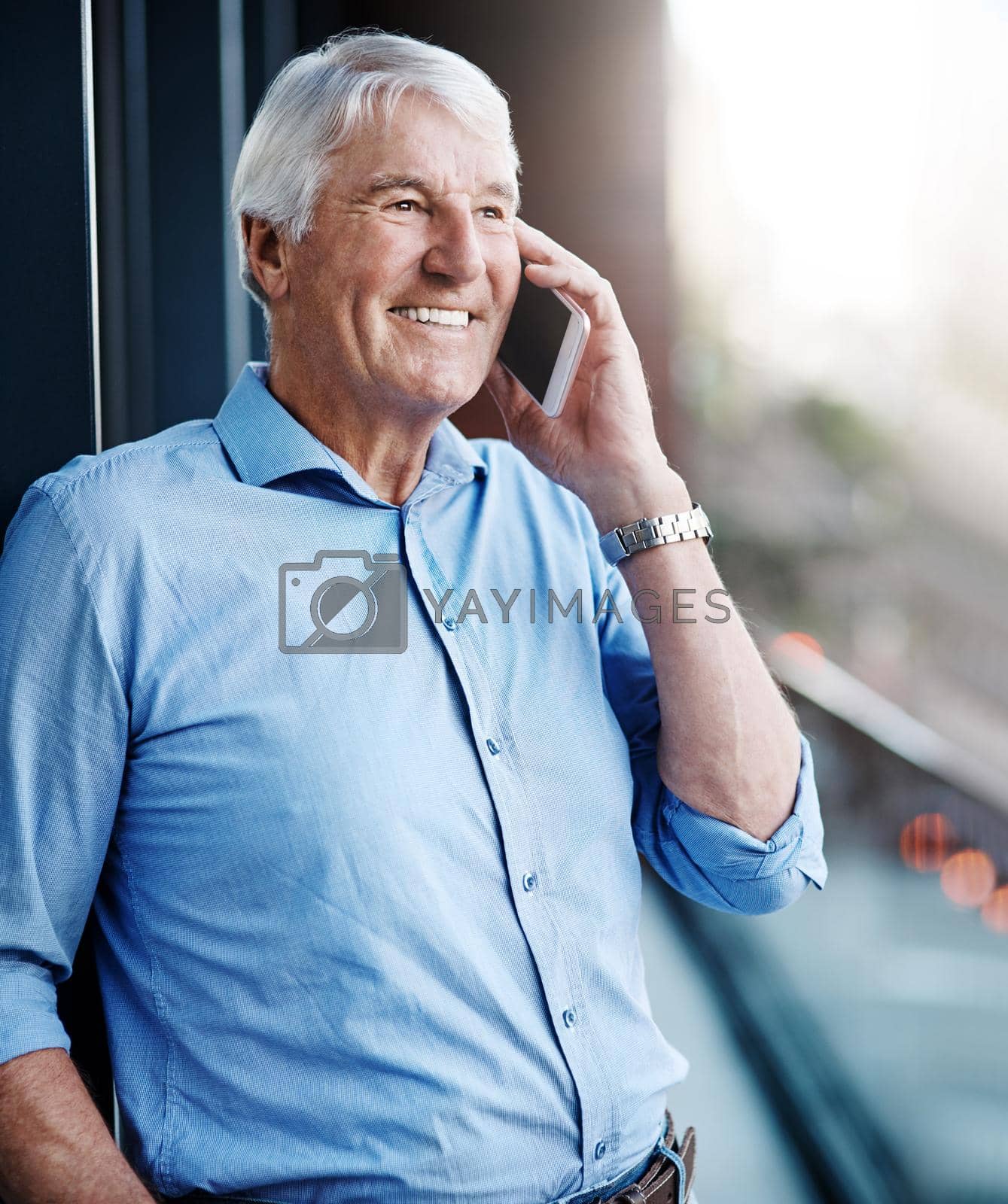 Royalty free image of Hes become an expert in talking to clients. a senior businessman on a call outside the office. by YuriArcurs